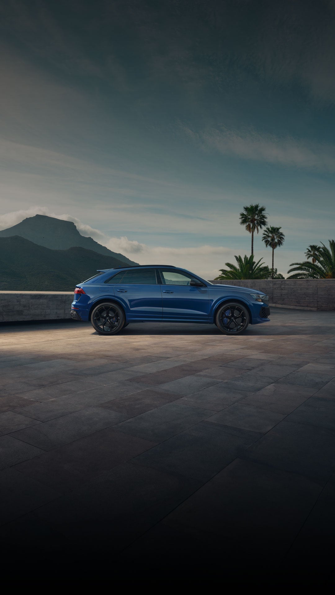 Side view of a red Audi RS Q8 parked. 