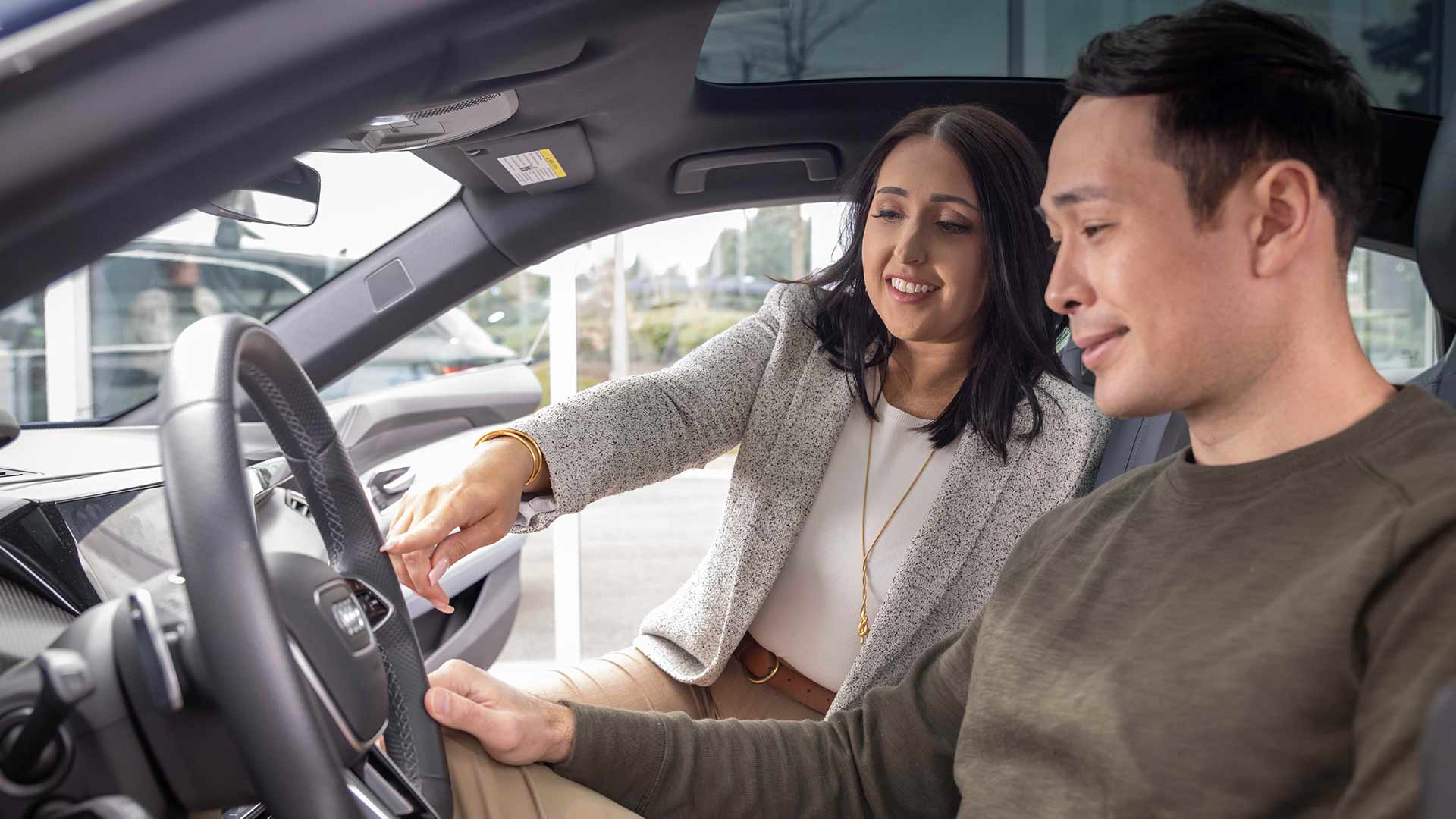 Audi Sale Specialist explaining vehicle features to a customer.