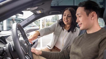 Audi Sales Specialist talking with a customer.