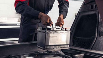 Service technician servicing battery