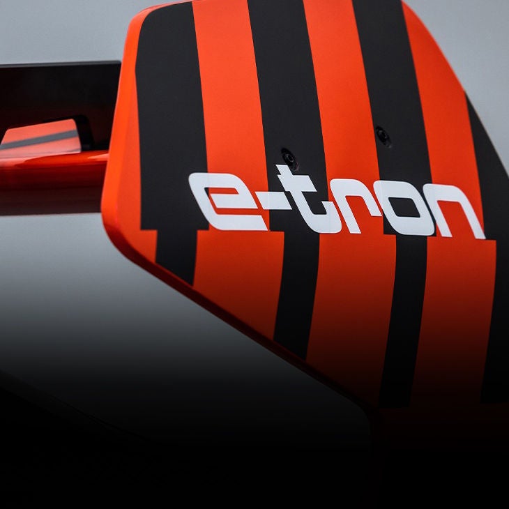 An Audi RS Q e-tron tackles a sand dune in the 2022 Abu Dhabi Desert Challenge.