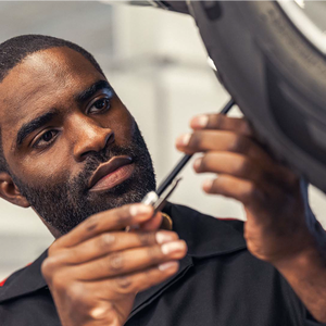 technician measure tire tread depth