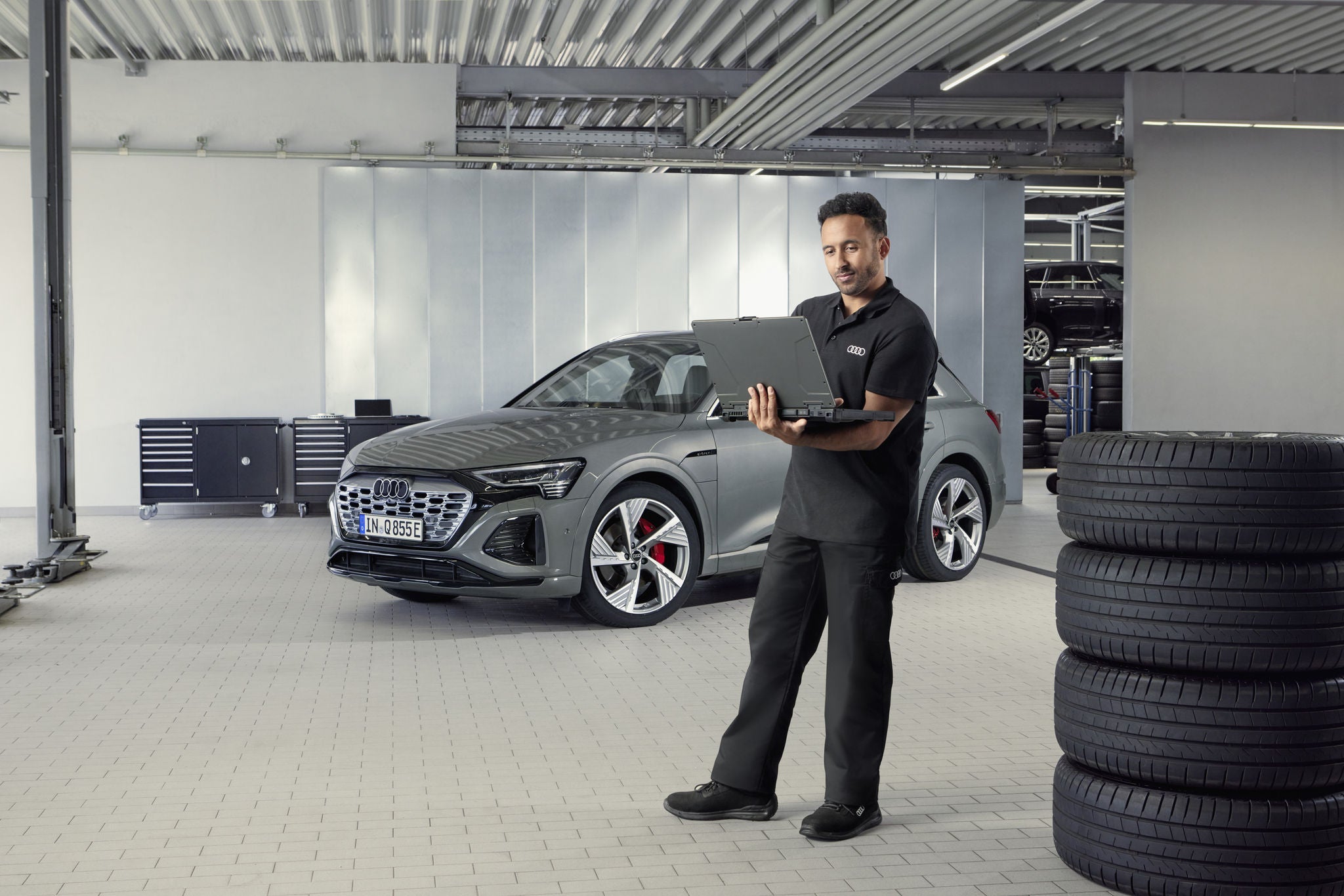 Audi service technician servicing a vehicle.