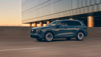 Side-view of the Audi Q7 accelerating on a city road.