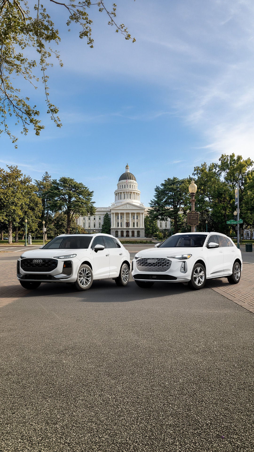 2026 Audi Q3 and 2026 Audi Q5 SUVs parked in front of the California State Capitol building in Sacramento.