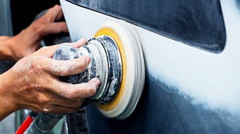 Service technician servicing cars