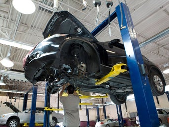 Service technician serving vehicle.