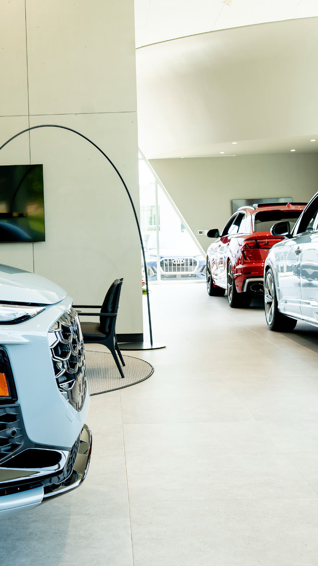 Rear profile view of audi vehicles parked in the showroom.