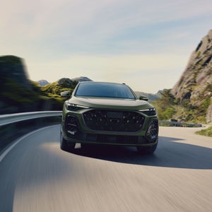 Front view of the Audi Q5 accelerating on a mountainside road.