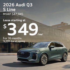 Side view of an Audi Q3 driving.