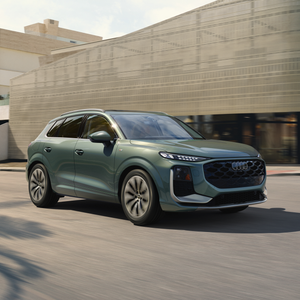 Side view of an Audi Q3 driving.