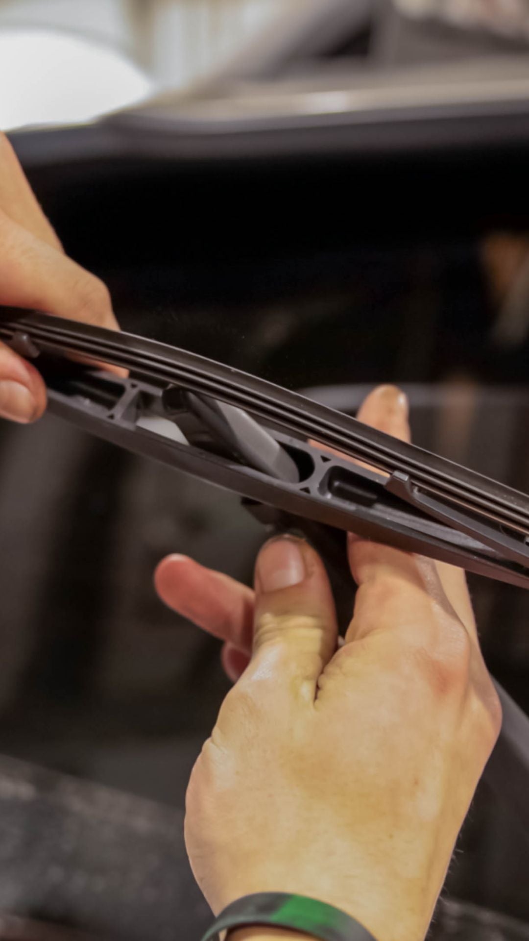 Service technician installing wiper blades.