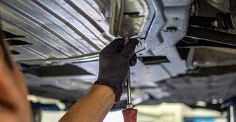 Service technician serving vehicle.