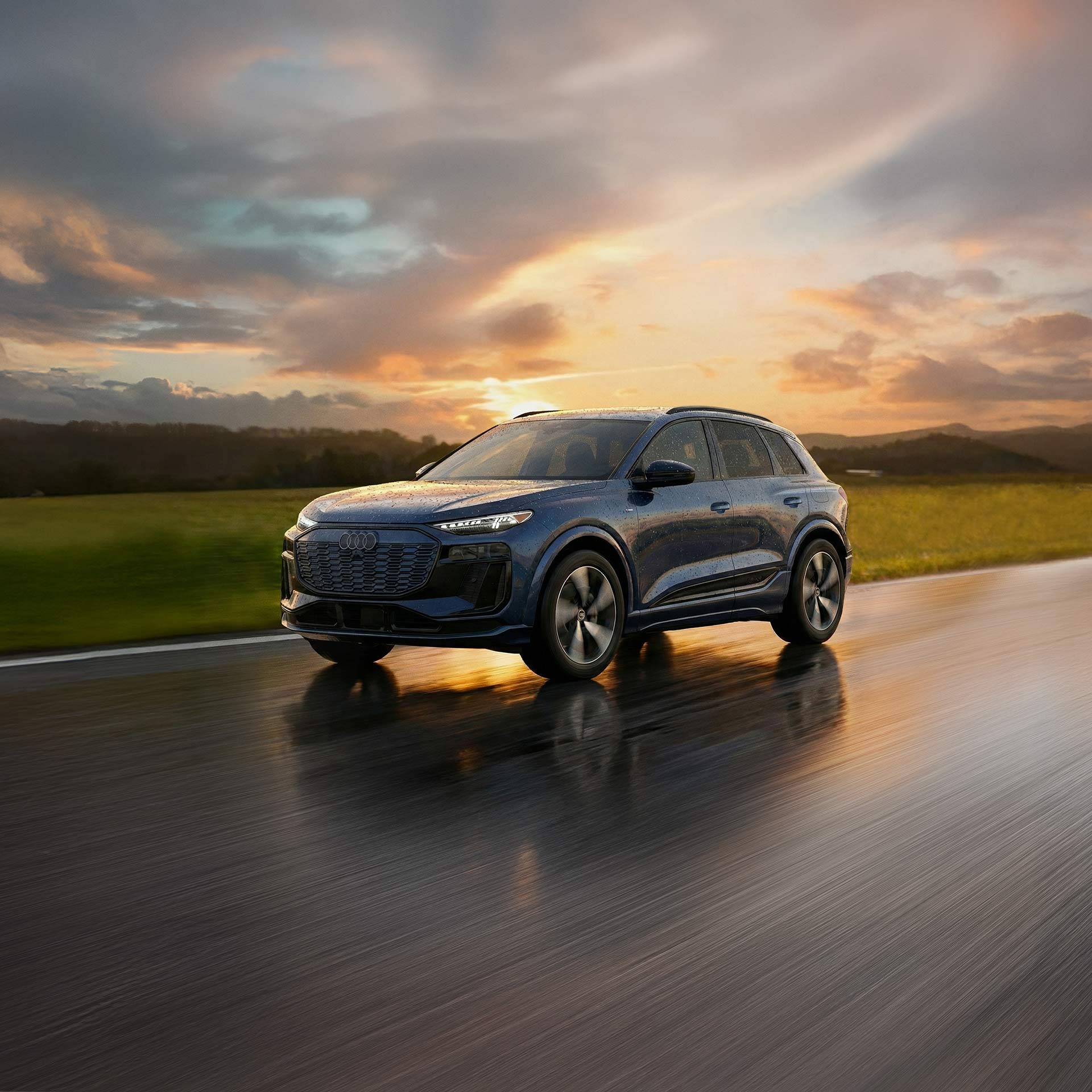 Three-quarter side profile of an Audi SQ6 accelerating.