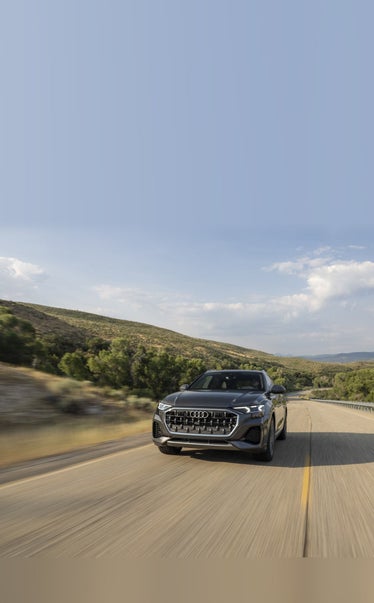 2026 Audi Q8 in Samurai Grey driving on a mountain road — Audi Sewickley