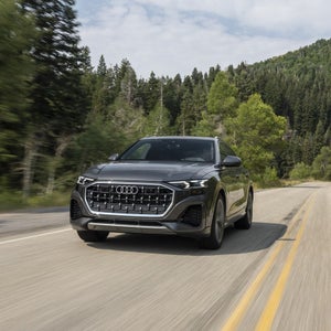 2026 Audi Q8 driving through pine forest — view inventory at Audi Sewickley near Pittsburgh PA