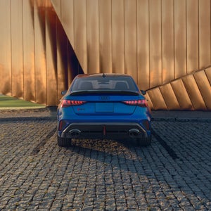 Back shot of the Audi RS 3 sedan parked.