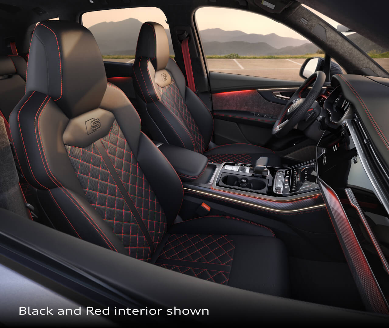 Interior front seat view of the 2026 Audi Q7 showing black and red leather