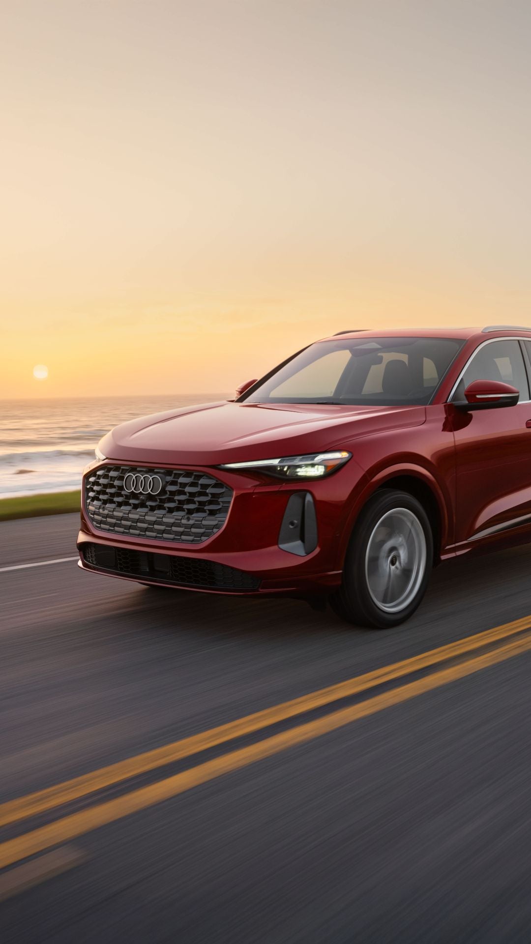 Three quarter profile view of an Audi Q5 accelerating.