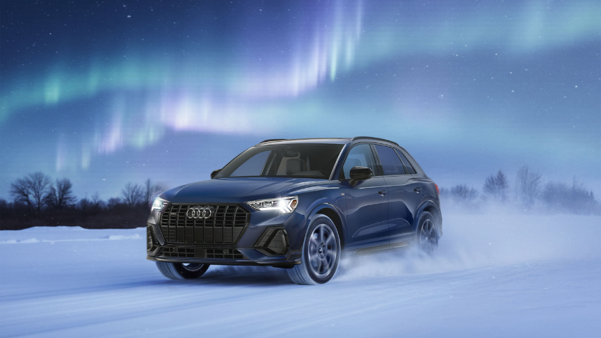 Three quarter view of an Audi q7 vehicle parked.