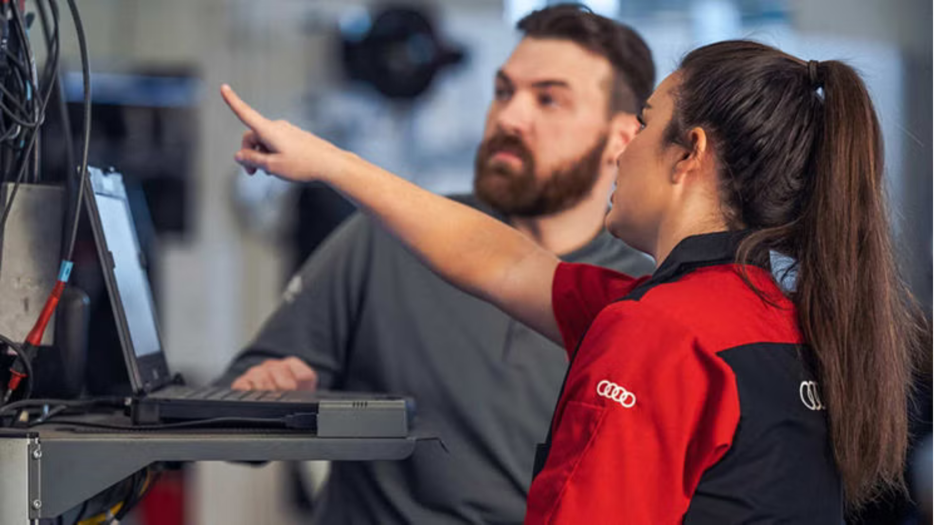 Audi service technician servicing a vehicle.