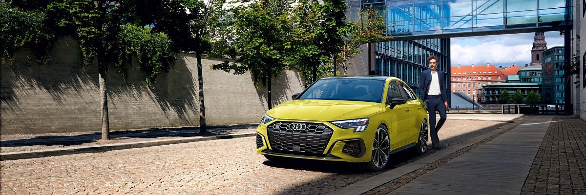 2026 Audi S3 with man standing beside it downtown