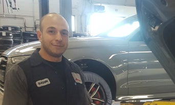 Image of Bassim Abosaid standing in front of an Audi vehicle 