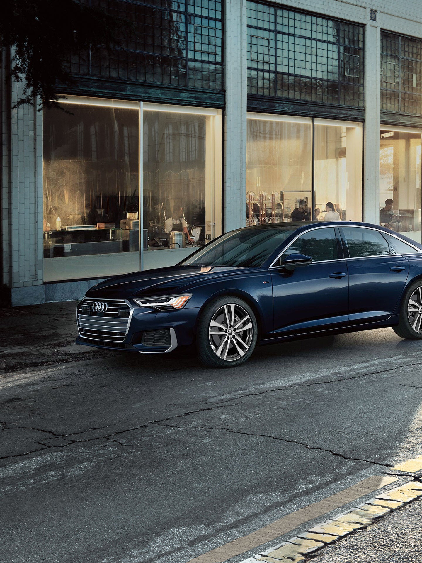 Three-quarter side view of the Audi A6 Sedan.