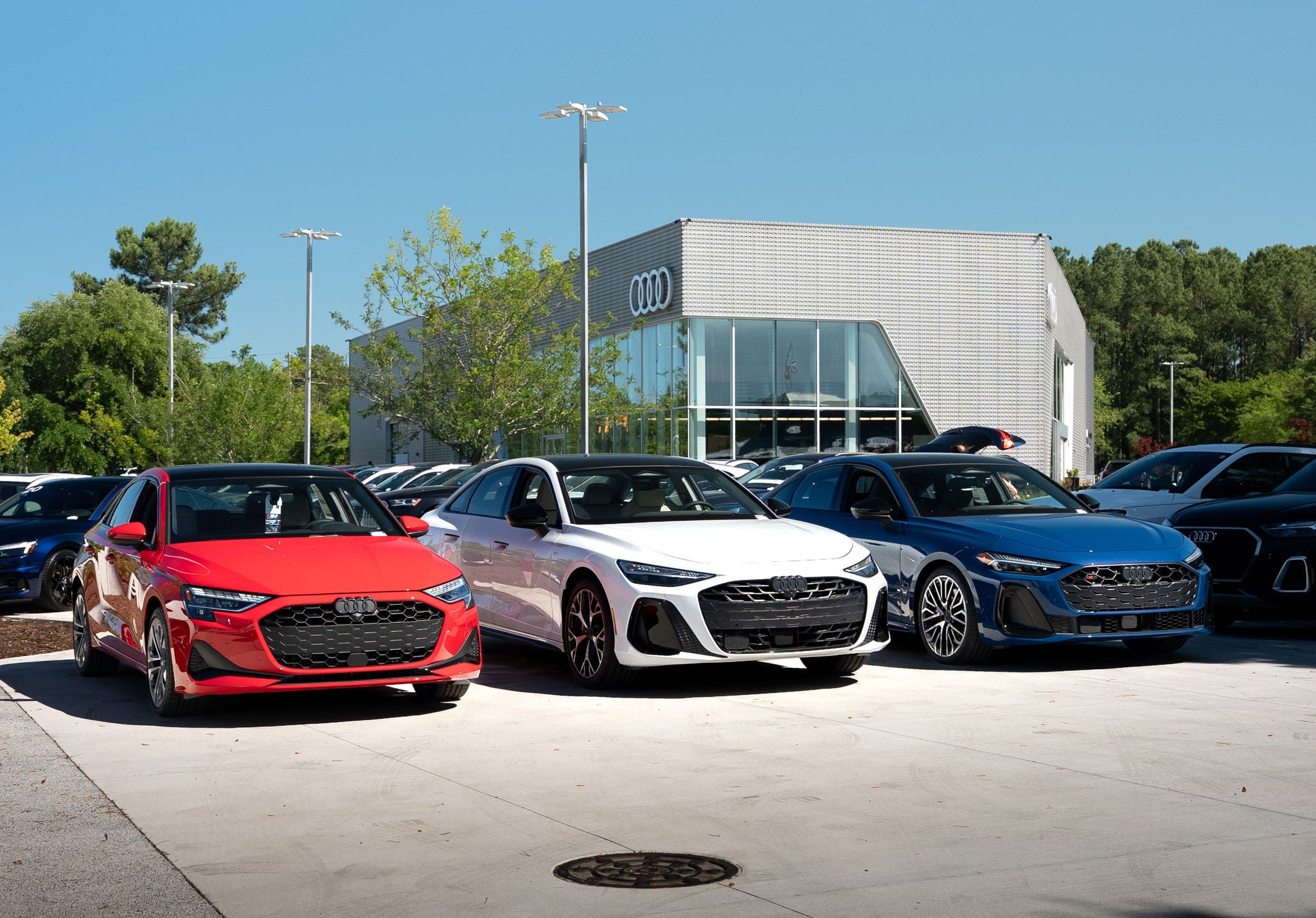 Red, white, and blue Audi sedans