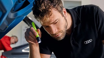 Service technician working on brake and rotor.