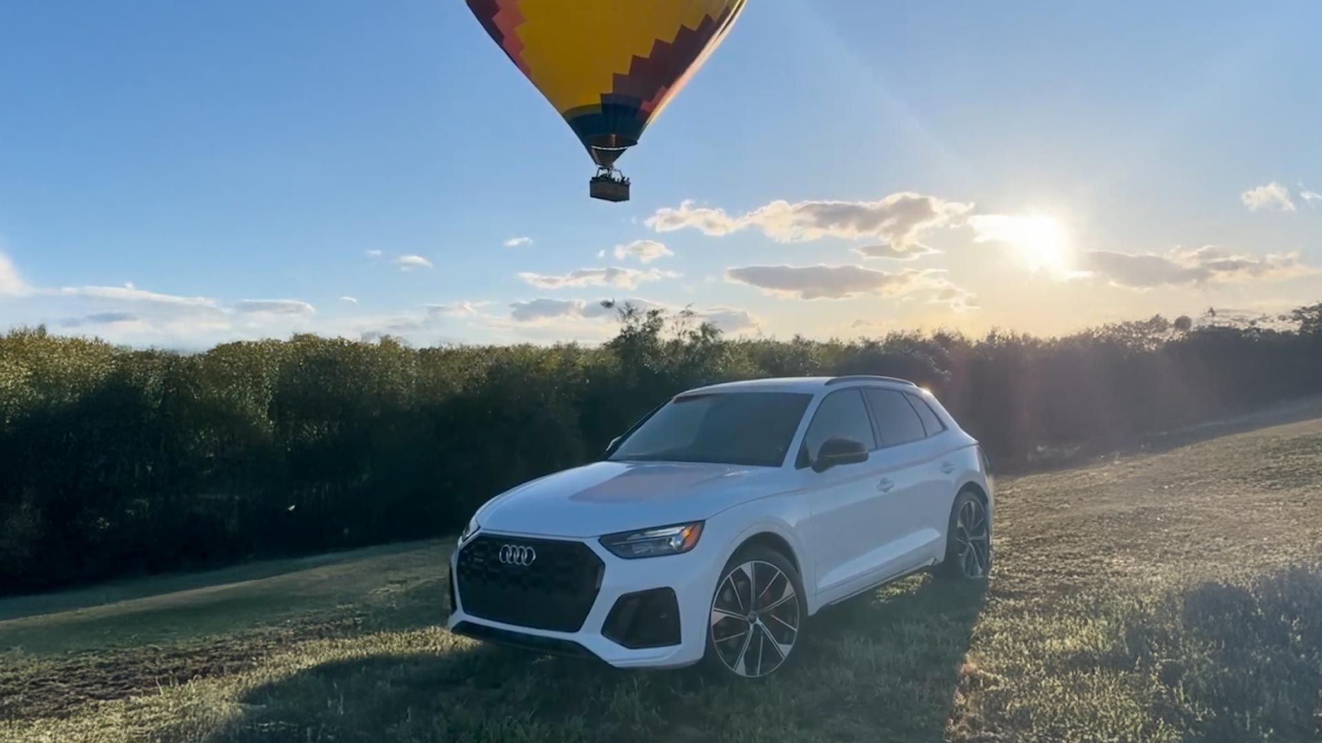 Left profile view of an Audi vehicle parked.