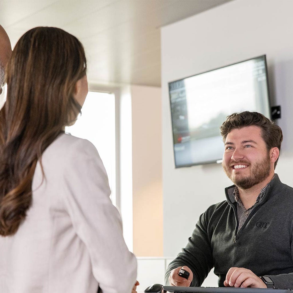 Audi Specialist handing keys to customer.