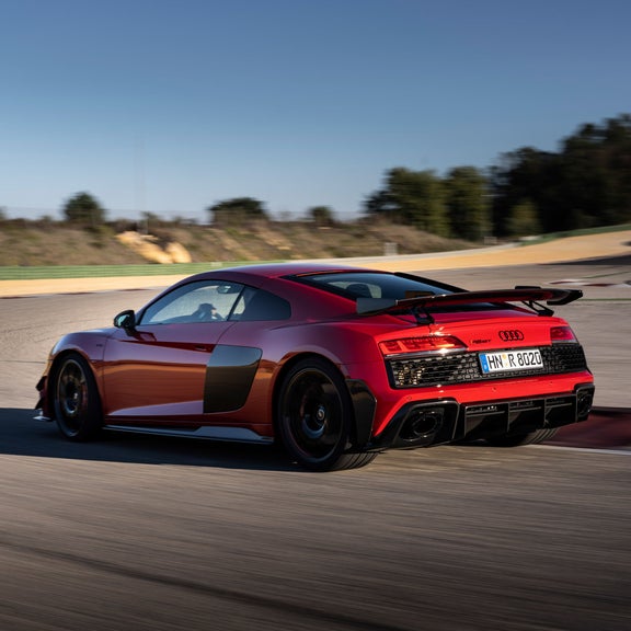 Three-quarter rear view of a red 2nd-generation Audi R8 GT in motion.