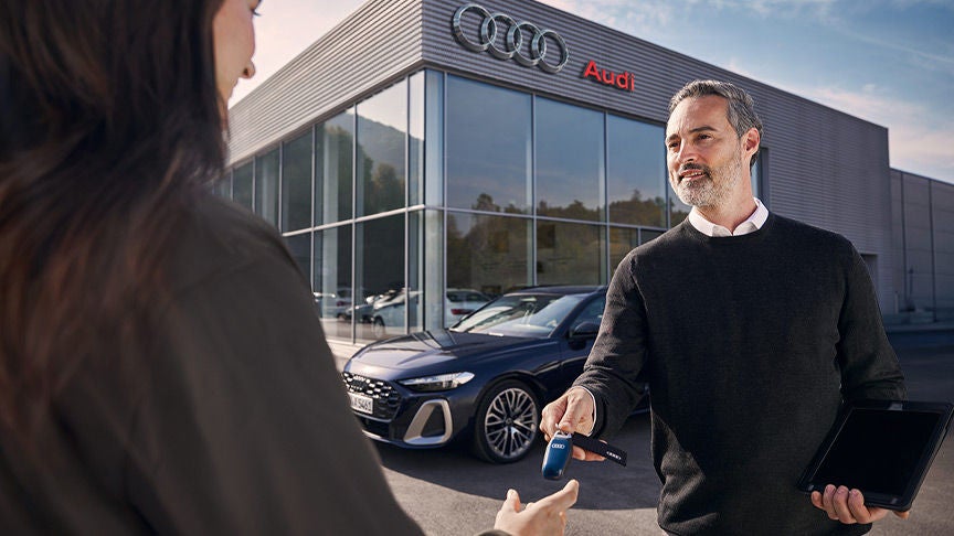 Sales staff delivering Audi keys