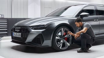 Audi Technician serving tire at Audi garage