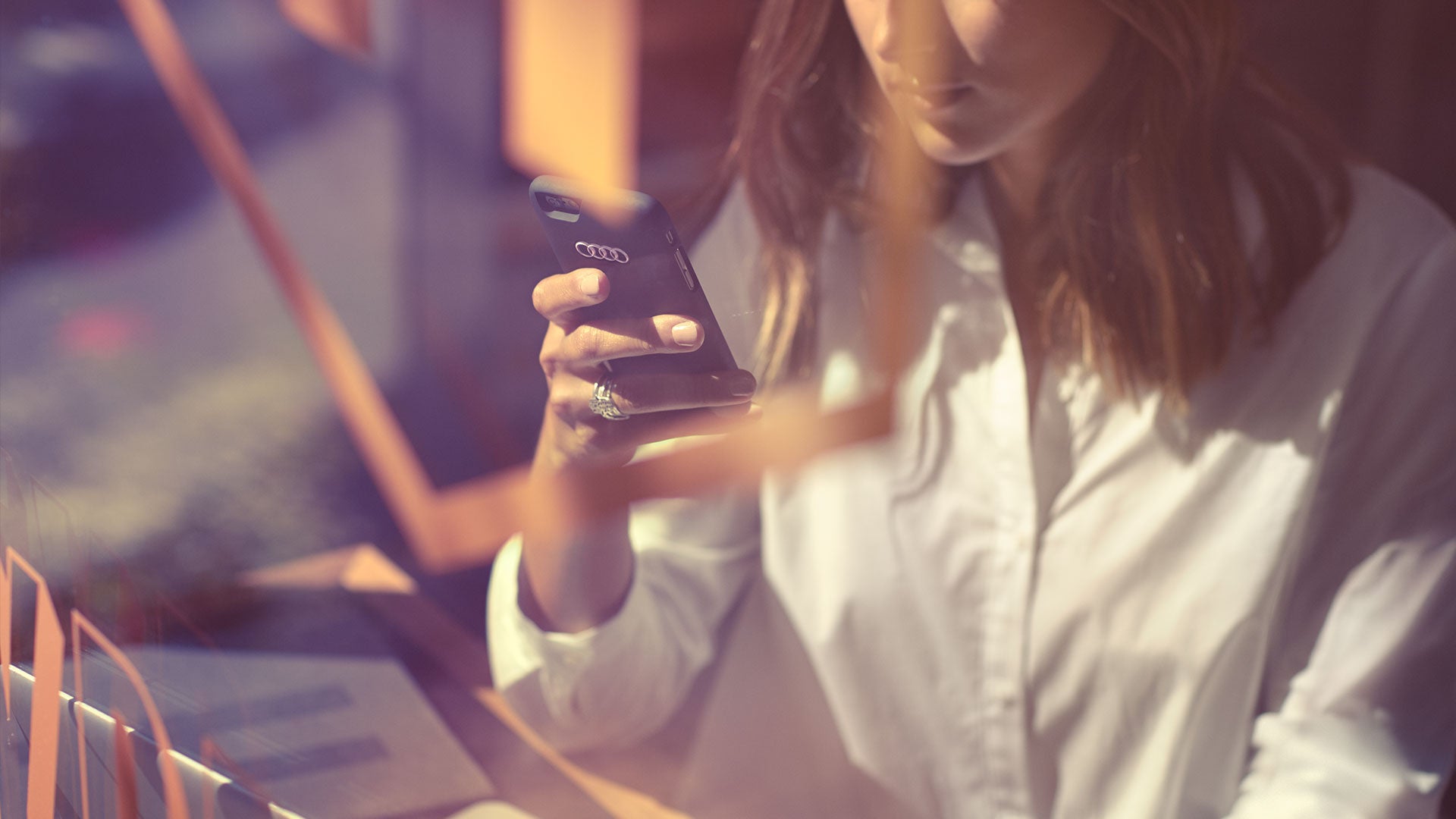 An Audi owner using the myAudi app on their smartphone.