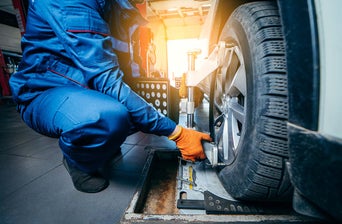 Mechanic performing a tire alignment
