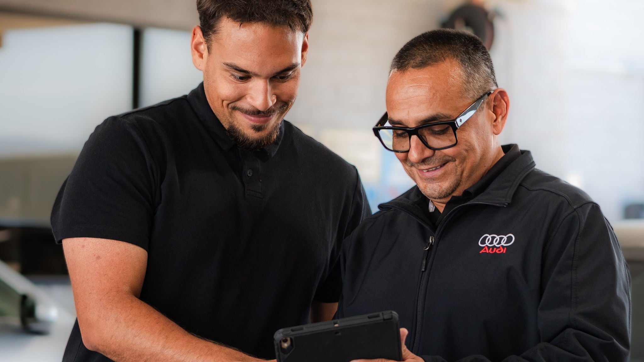 Audi service technician servicing a vehicle.