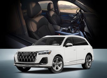 Exterior view of a white Audi Q7 Premium with the interior front seat of the car in the background