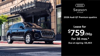 Audi Q7 parked by a building