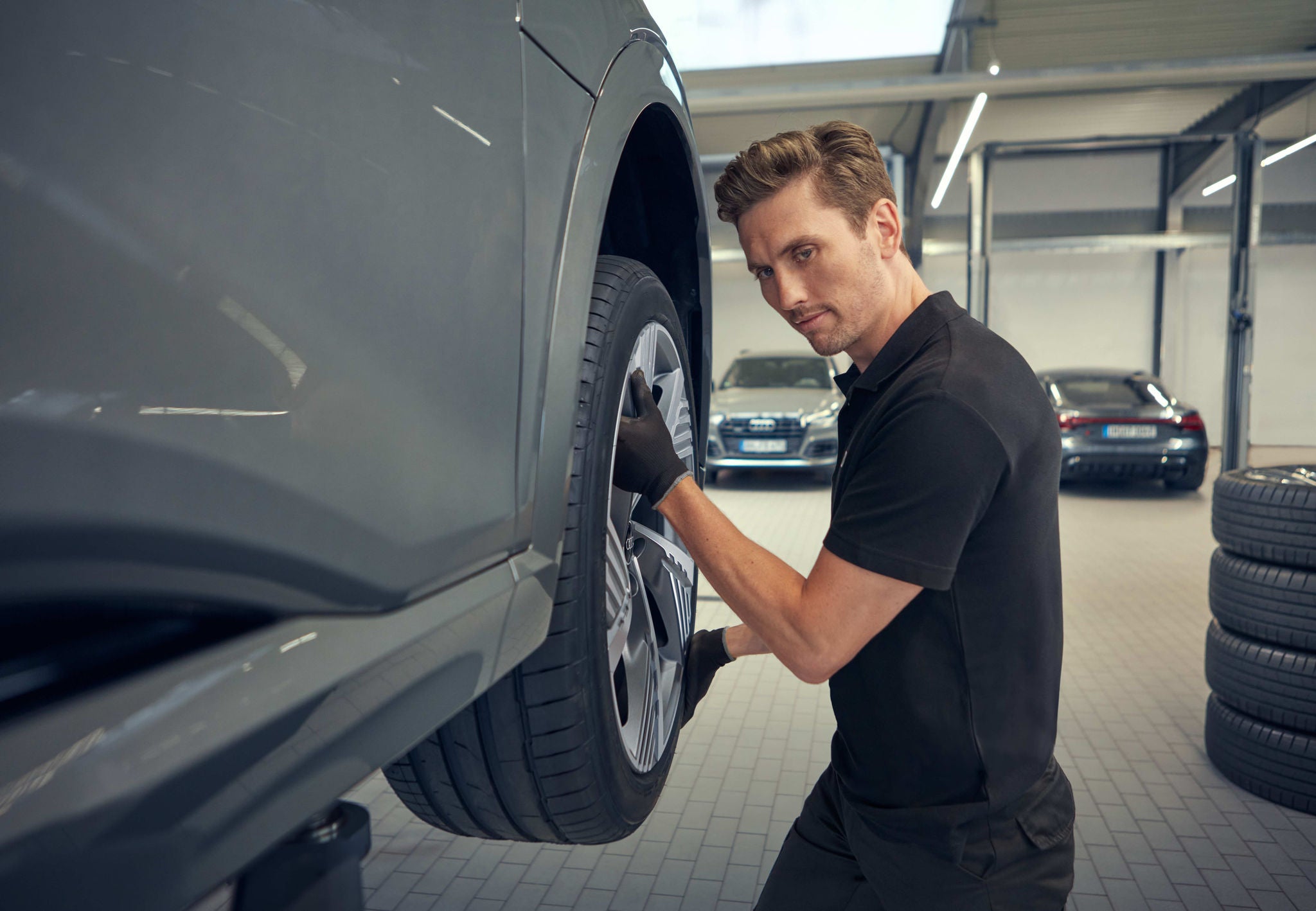 Mechanic inspecting the engine of an Audi vehicle