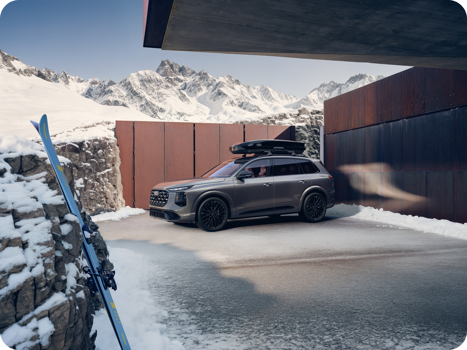 2027 Audi SQ7 with roof box in a snowy mountain setting.