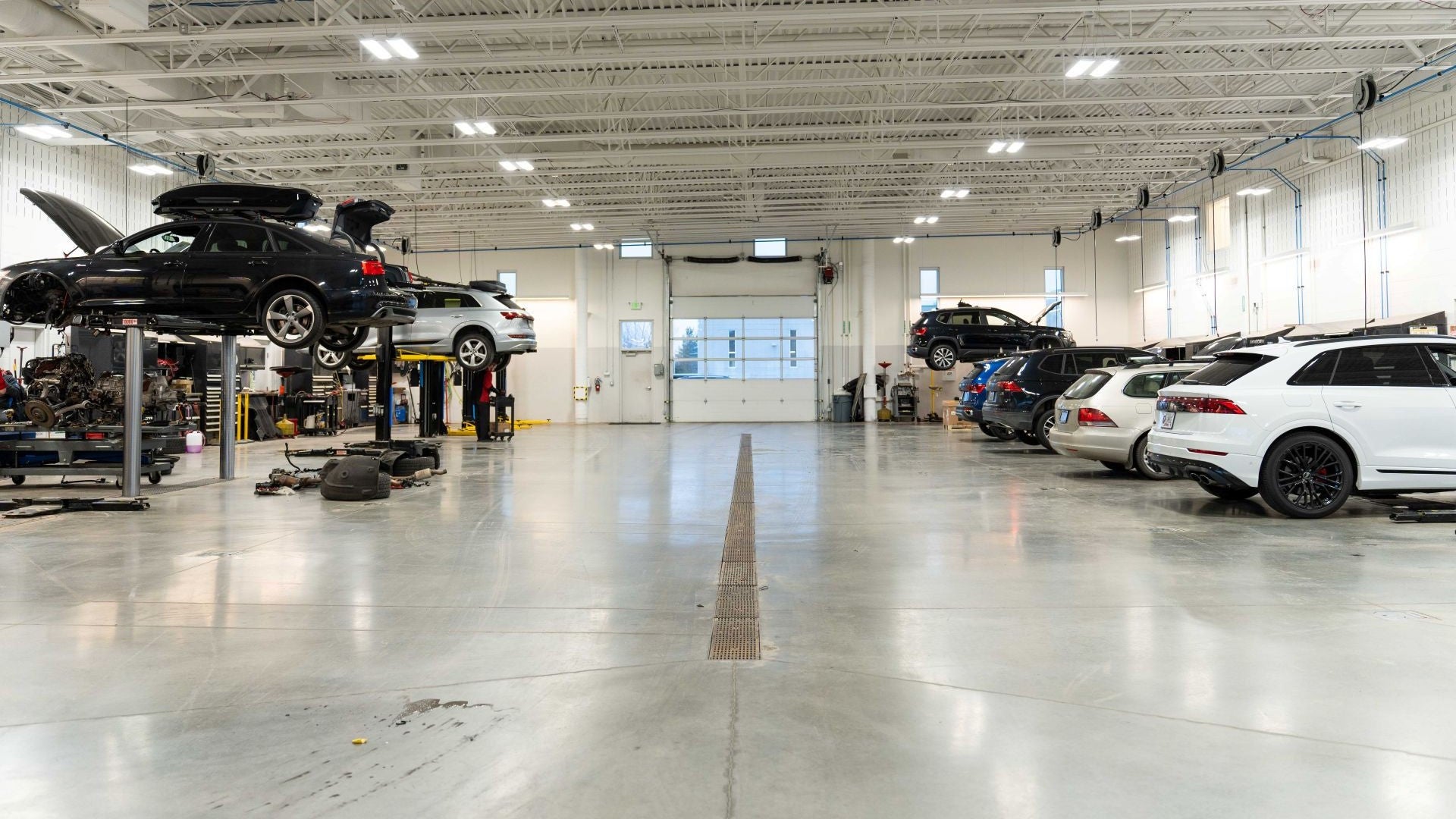 Audi certified mechanic checking oil