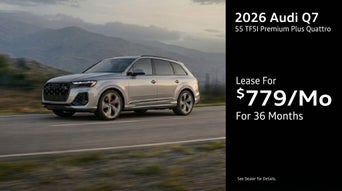 Three quarter view of an Audi Q7 driving.