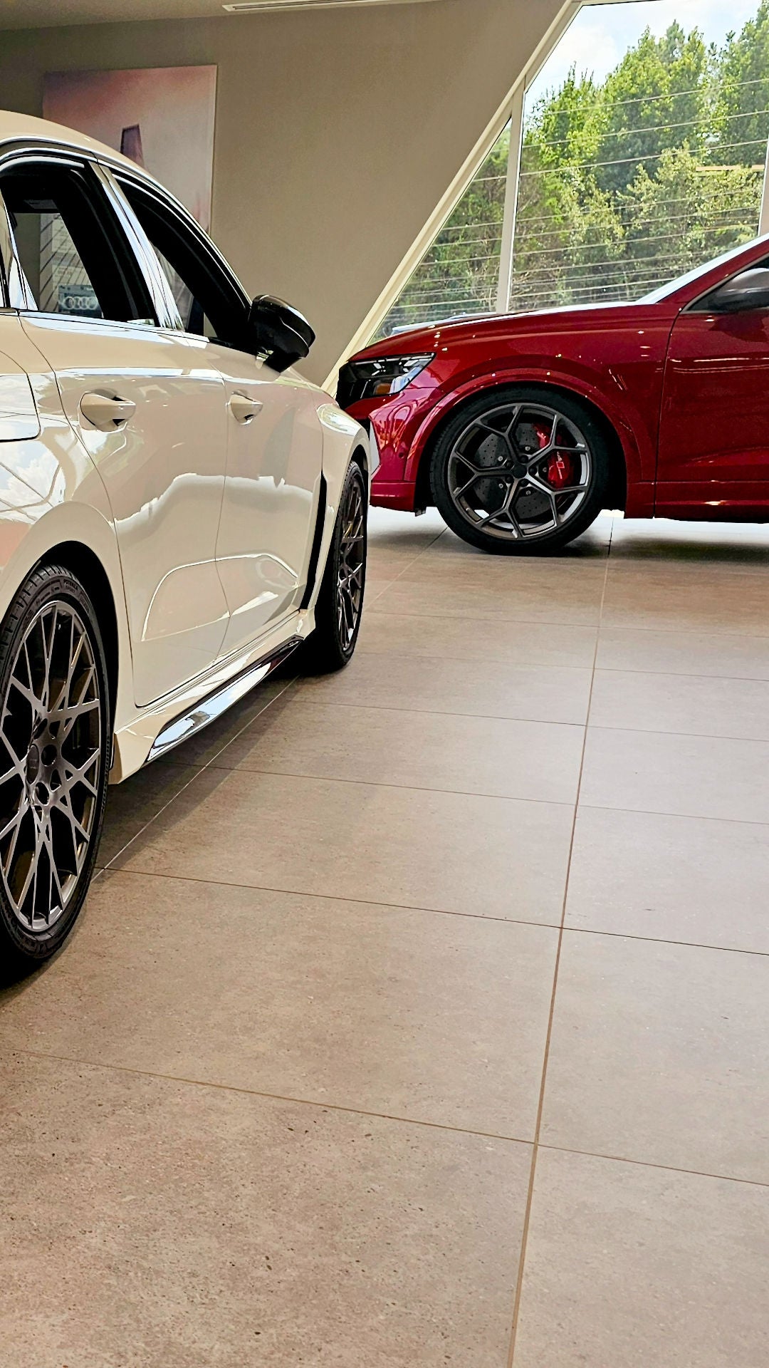 Side view of an Audi parked in front of the Audi Huntsville dealership