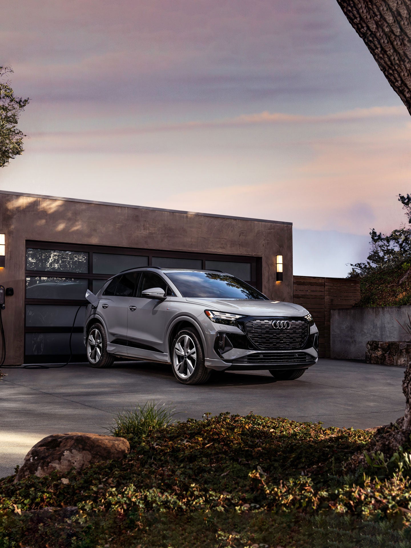 Three-quarter front view of the Audi Q4 e-tron® charging.