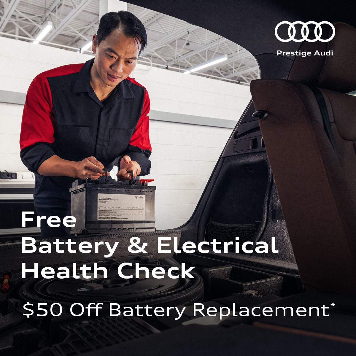 Audi Technician installing a battery in an Audi SUV.