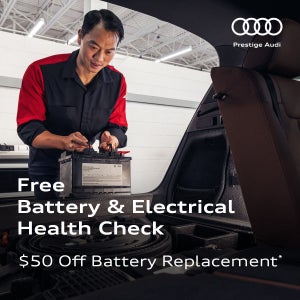 Audi Technician installing a battery in an Audi SUV