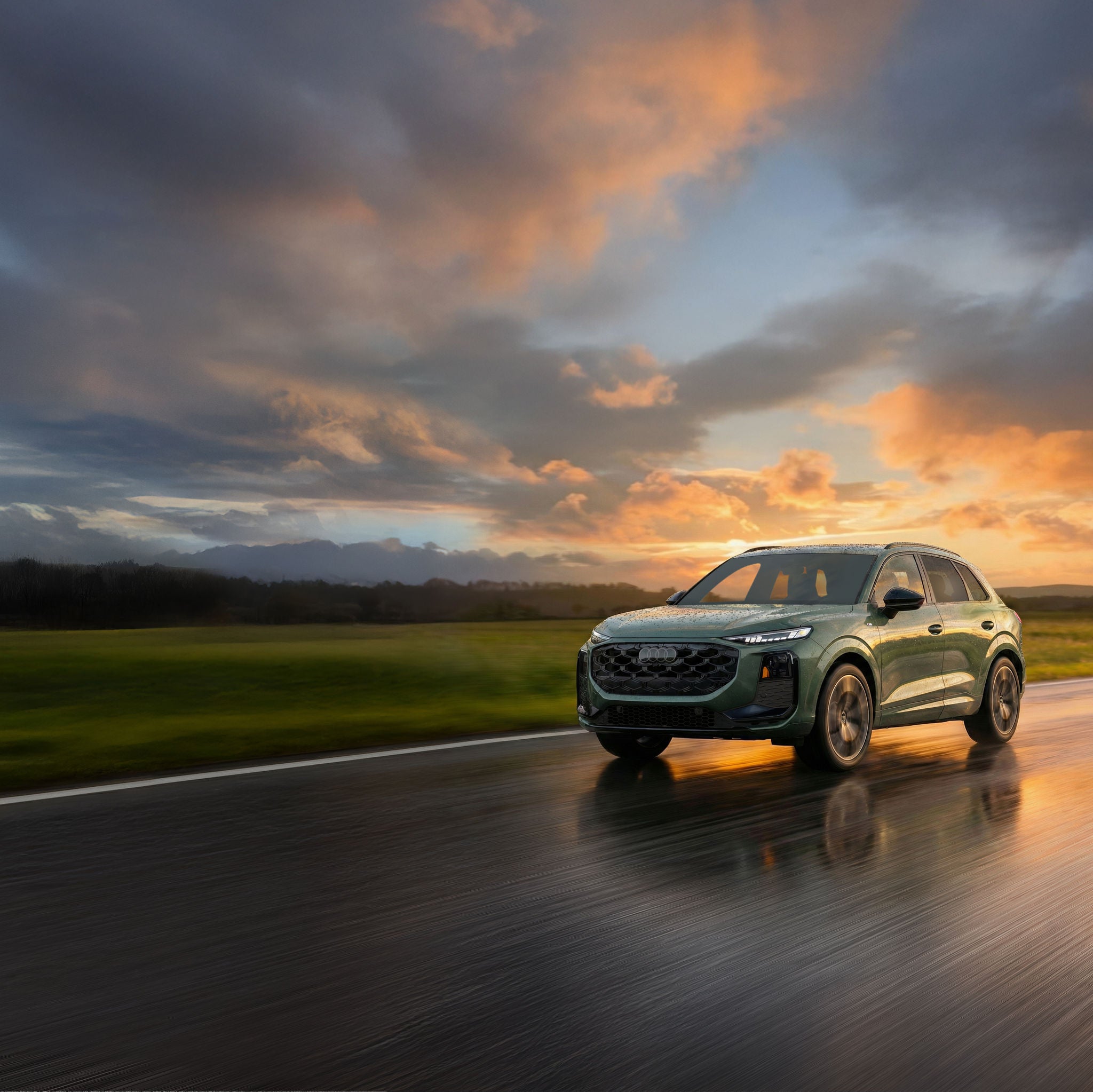 Side profile of an Audi Q3 accelerating.