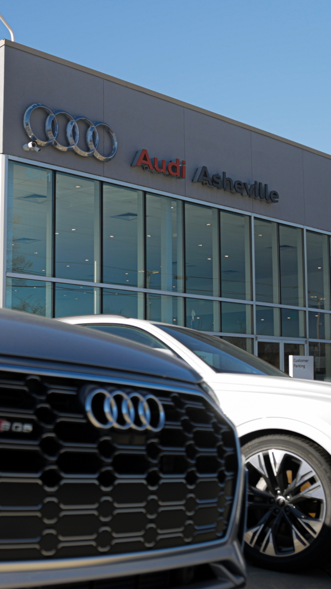 Audi vehicles parked in front of the Audi Asheville dealership